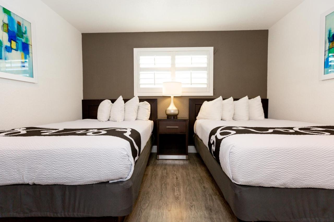 Room with One Queen and Two Double Beds at SureStay Hotel by Best Western Seaside Monterey