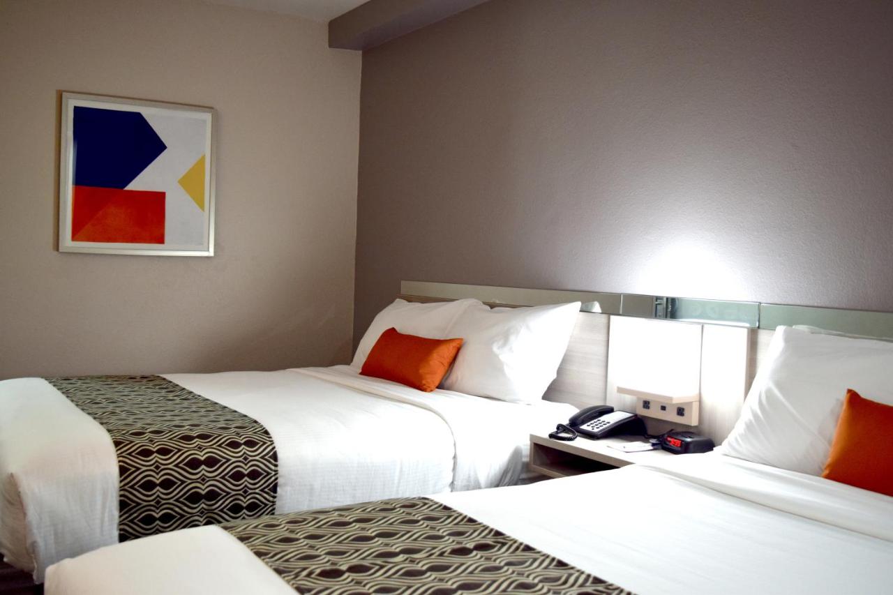 Queen Room with Two Queen Beds - Non-Smoking at Microtel Inn & Suites by Wyndham Raleigh