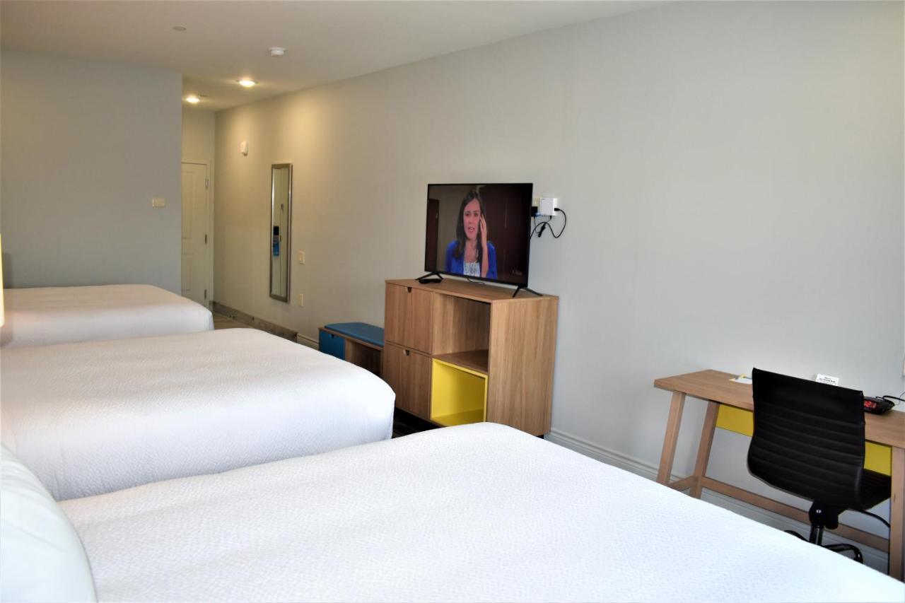 Queen Room with Three Queen Beds - Non-Smoking at Days Inn & Suites by Wyndham Downtown/University of Houston