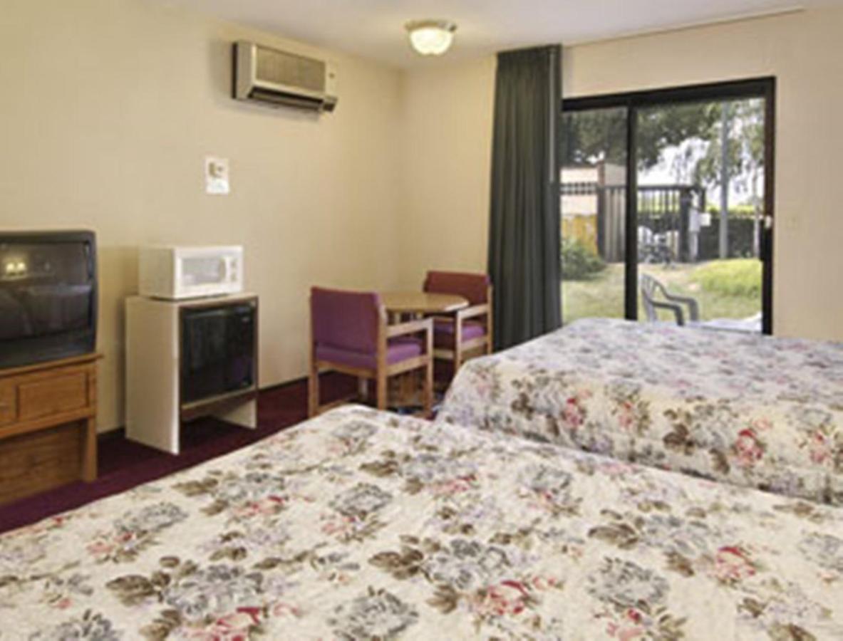 Queen Room with Two Queen Beds and Pool View - Non-Smoking at Travelodge by Wyndham Turlock