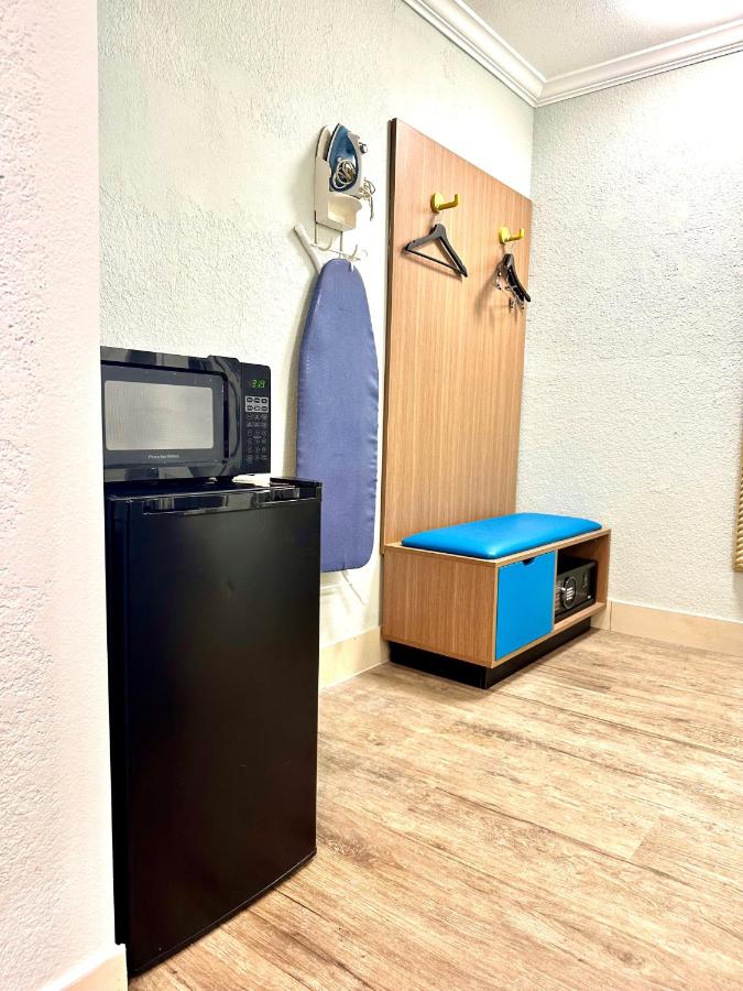 Room with One King and Two Double Beds - Non-Smoking at Days Inn by Wyndham Pensacola - Historic Downtown