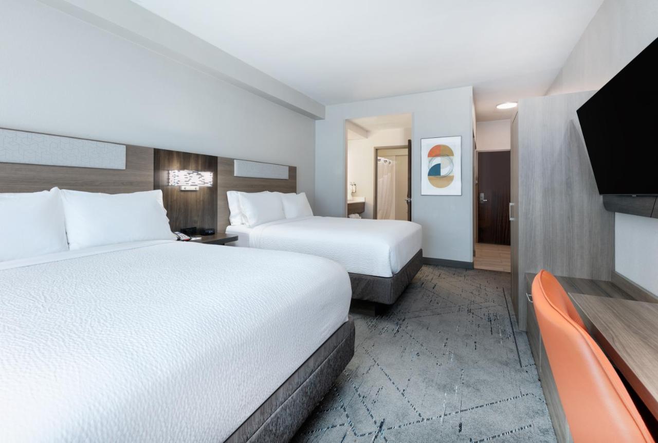Queen Room with Two Queen Beds Hearing Accessible Bathtub - Non-Smoking at Holiday Inn Express & Suites Dallas Park Central Northeast, an IHG Hotel