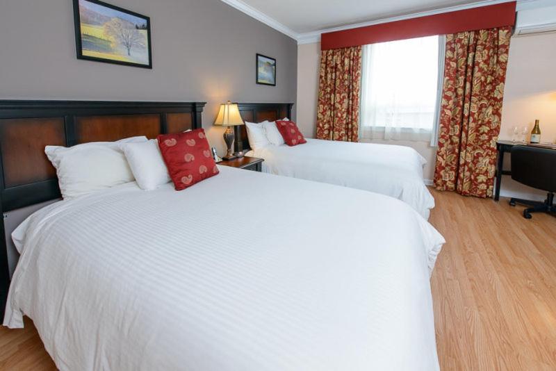 Queen Room with Two Queen Beds at Norwalk Inn & Conference Center