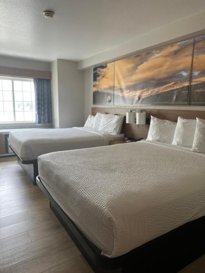 Queen Room with Two Queen Beds - Mobility Access/Non-Smoking at Days Inn & Suites by Wyndham Greeley