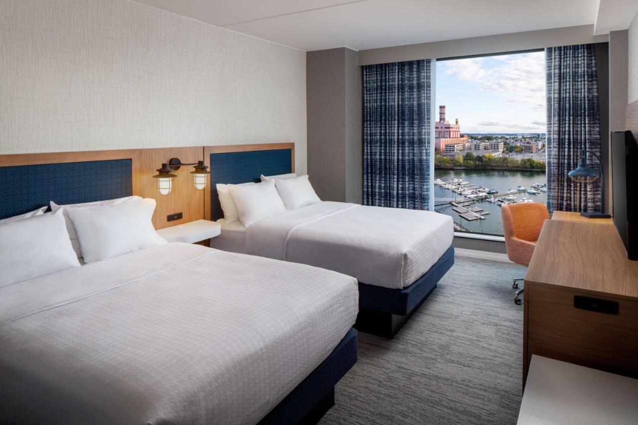 Queen Room with Two Queen Beds and Water View - Hearing Accessible at Hampton by Hilton at the Boston Seaport District