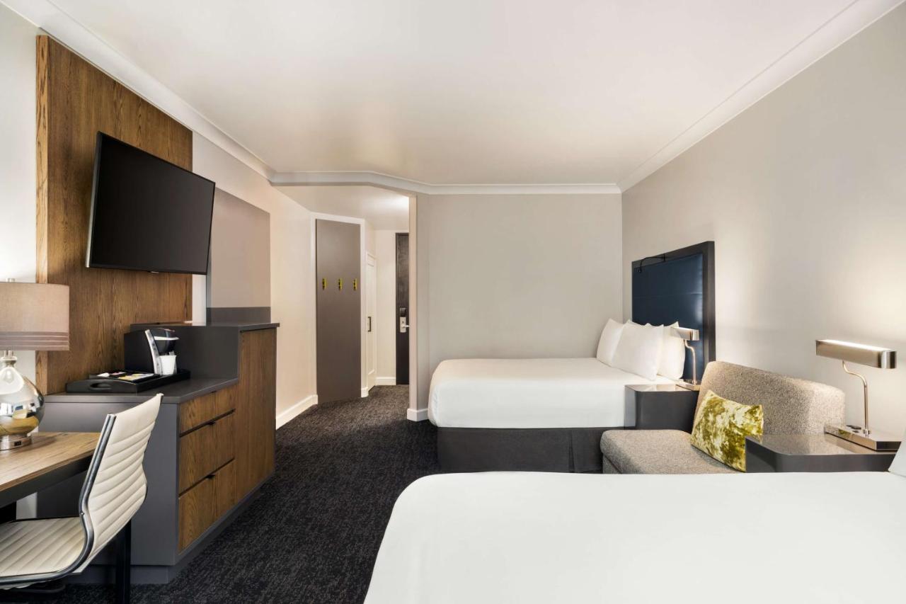 Queen Guestroom with Two Queen Beds and Skyline View at Hilton Motif Seattle
