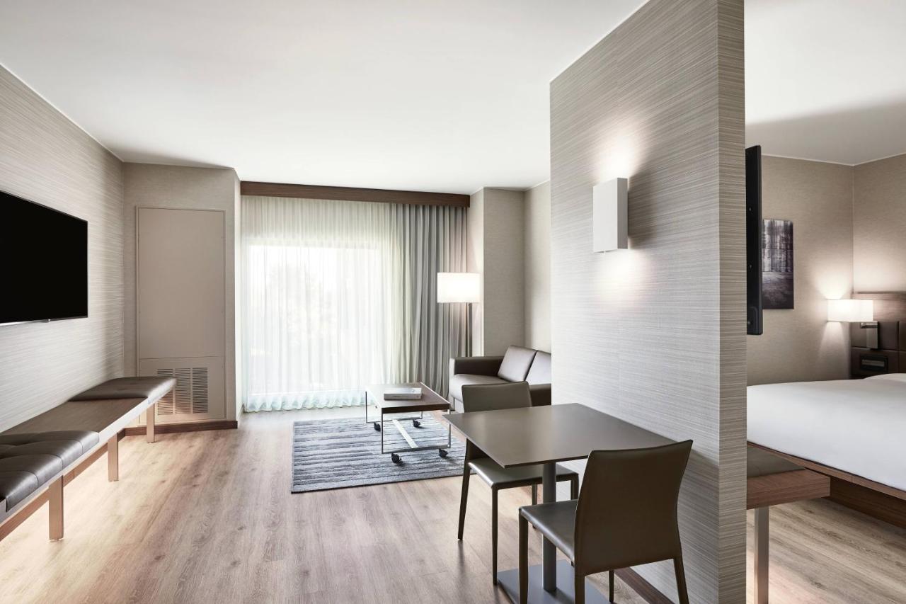 Junior Suite with king bed, sofa and pool view at AC Hotel by Marriott Phoenix Biltmore