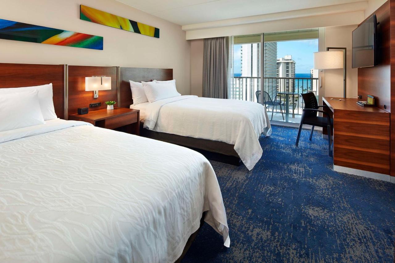 Suite with Two Double Beds and One Sofa Bed with Partial Ocean View at Hilton Garden Inn Waikiki Beach