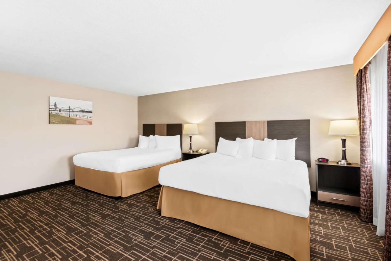 Large Room with One King and One Queen Bed at Best Western Airport Inn