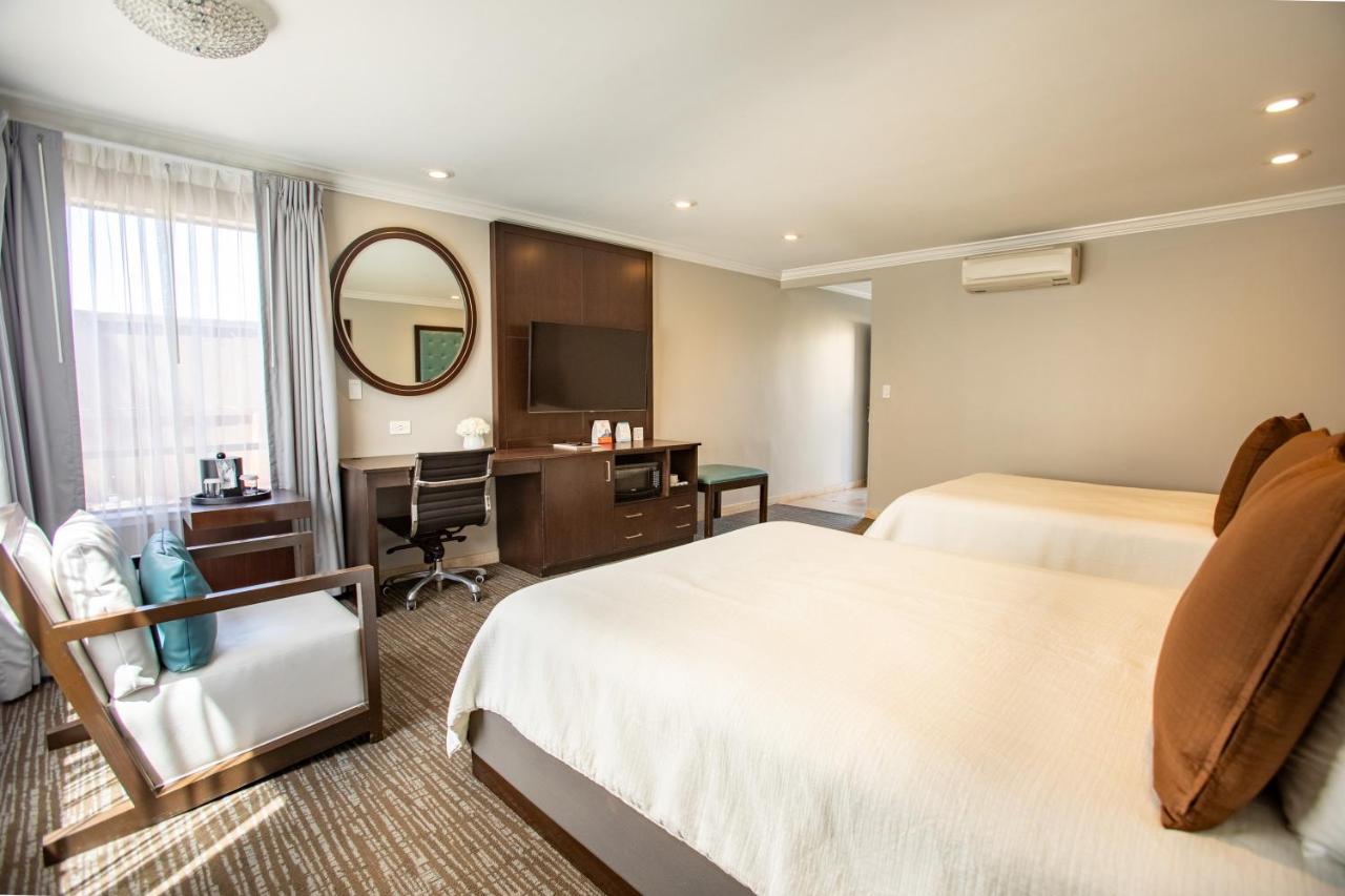 Queen Room with Two Queen Beds and Fireplace at Munras Inn