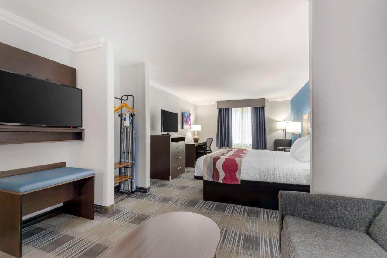 King Suite with Sofa Bed and Dining Table at Best Western Medical Center North Inn & Suites Near Six Flags