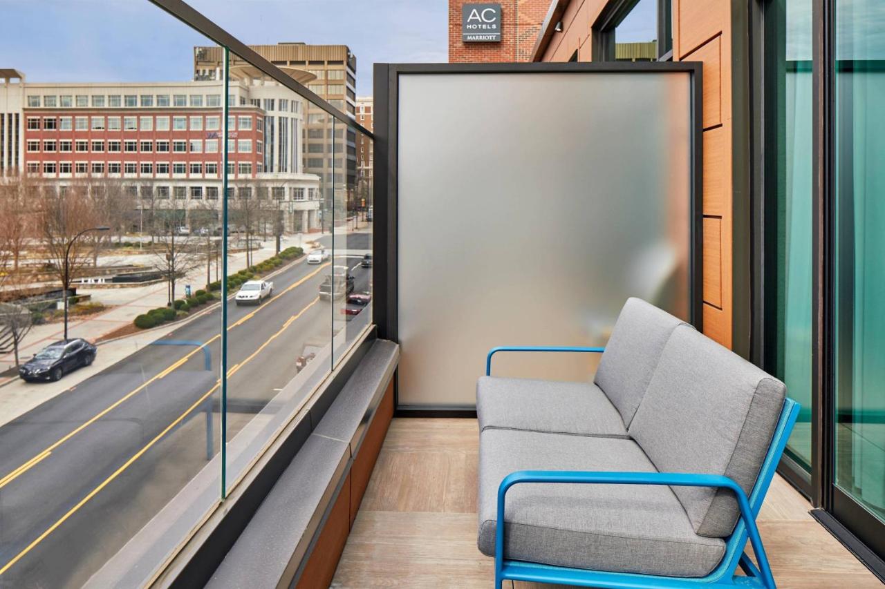 Guest room with king bed, sofa bed, balcony and city view at AC Hotel By Marriott Greenville