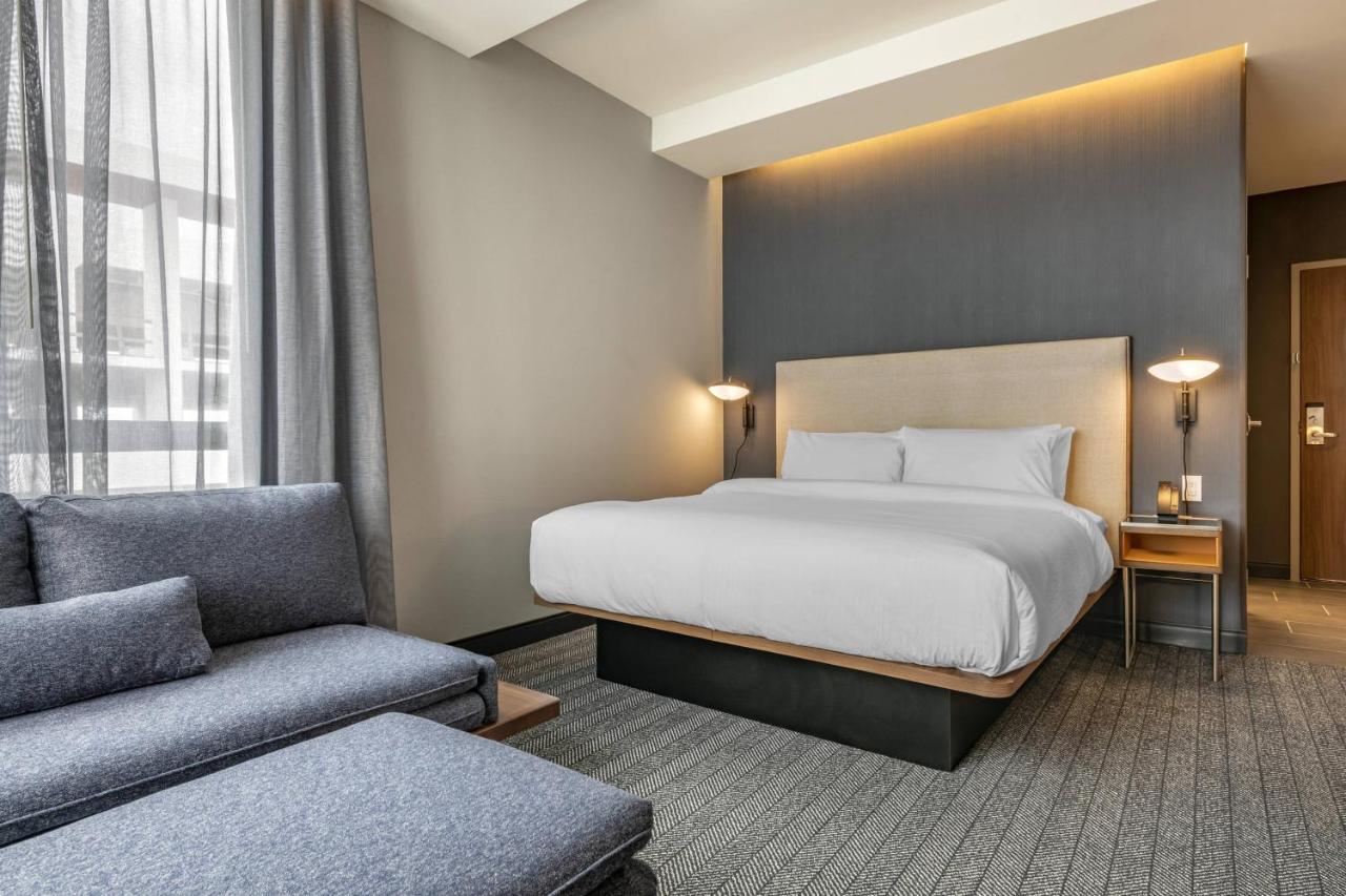 Corner room with king bed, sofa bed and city view at Courtyard by Marriott Fort Lauderdale Downtown