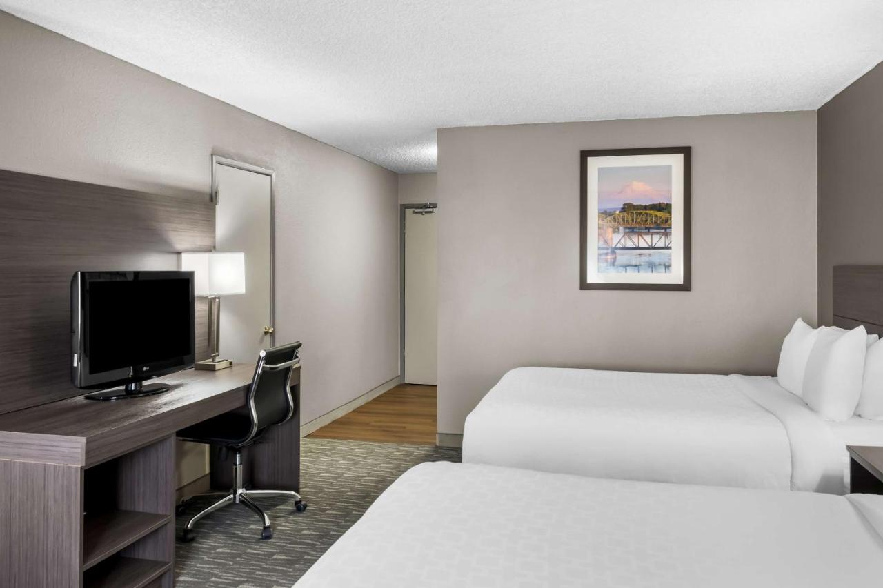 Queen Room with Three Queen Beds at SureStay Hotel by Best Western SeaTac Airport North