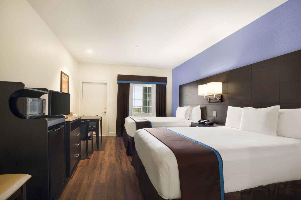 Queen Room with Two Queen Beds - Non-Smoking at Days Inn & Suites by Wyndham Galveston West/Seawall