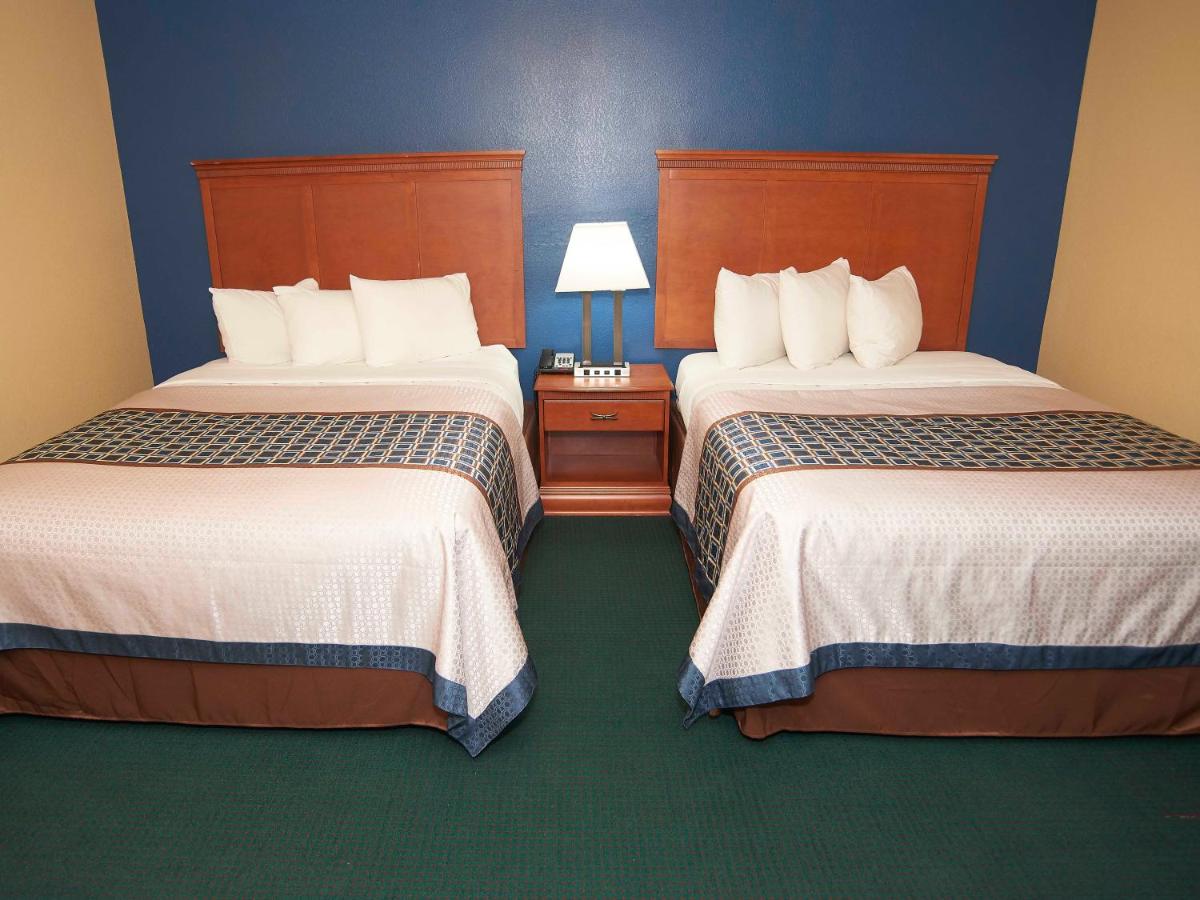 Two Queen Beds with Fire Place and Spa Bath at Swiss Chalets Village Inn