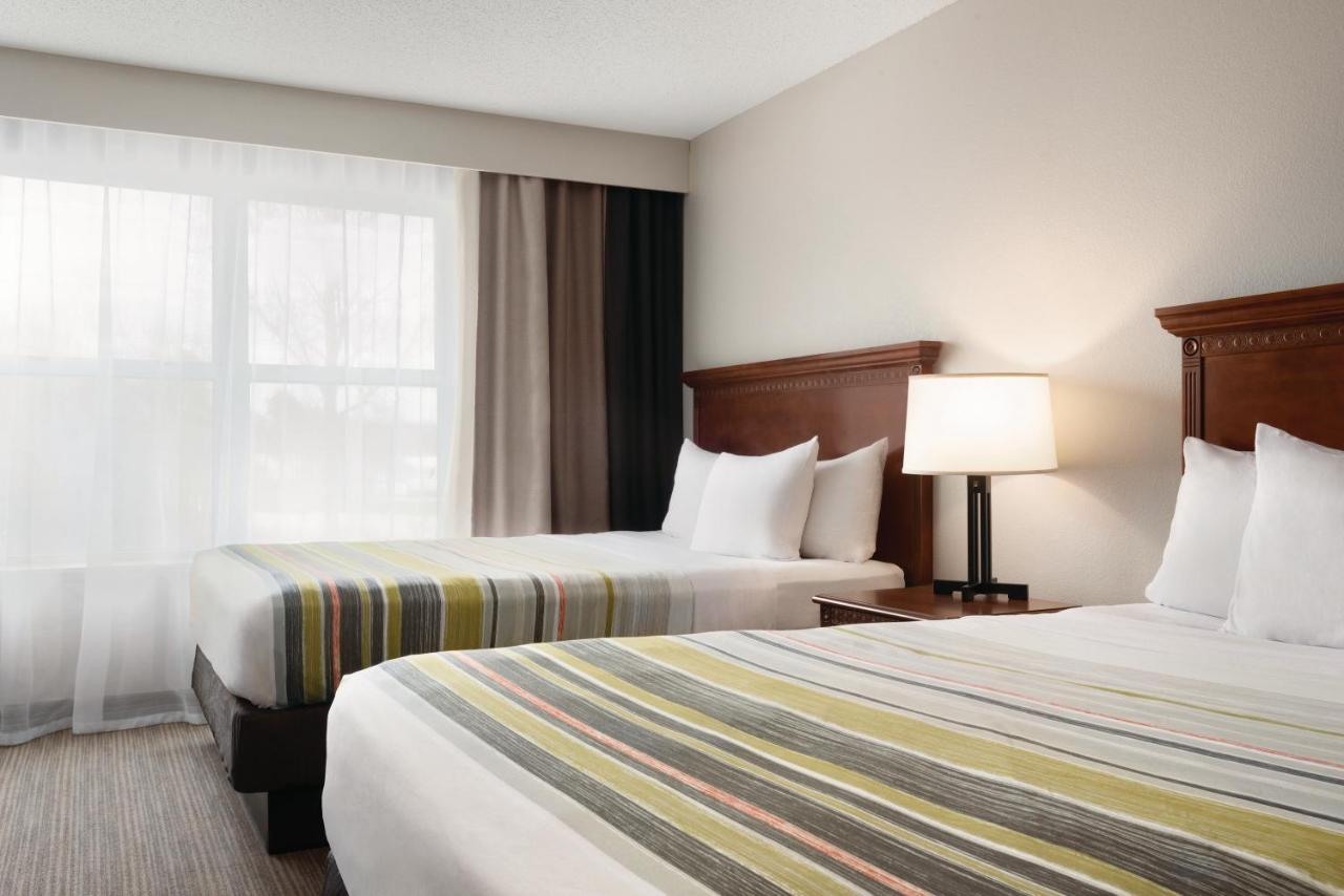 Queen Room with Two Queen Beds with Sofa Bed at Country Inn & Suites by Radisson, Marinette, WI