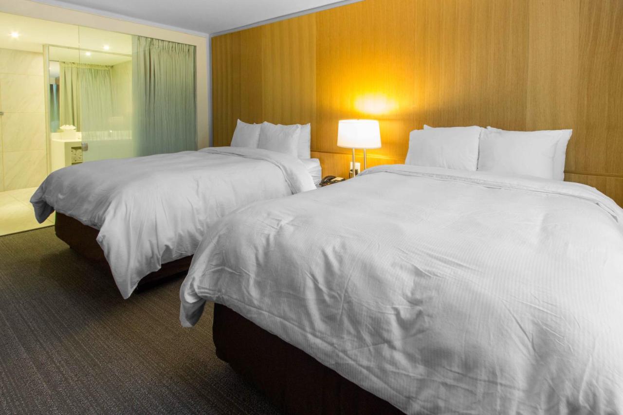Queen Room with Two Queen Beds and Garden View - Non-Smoking at West Wing Hotel, an Ascend Hotel Collection Member