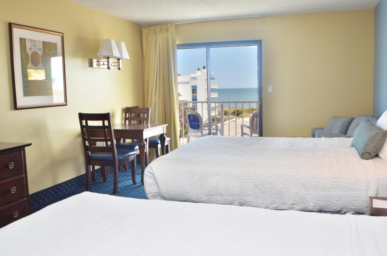 Partial Ocean View 2 Queens & Sofa - No Pets Allowed at Coastal Palms Inn & Suites