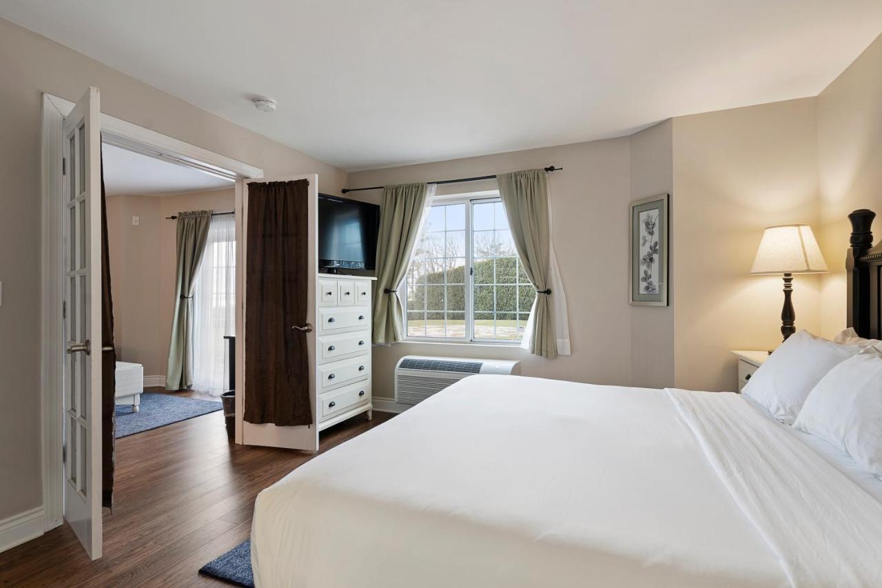 King Suite with Sofa Bed and Lake View at Charlevoix Inn & Suites SureStay Collection by Best Western