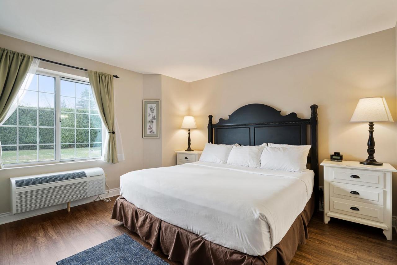 King Suite with Sofa Bed and Lake View at Charlevoix Inn & Suites SureStay Collection by Best Western