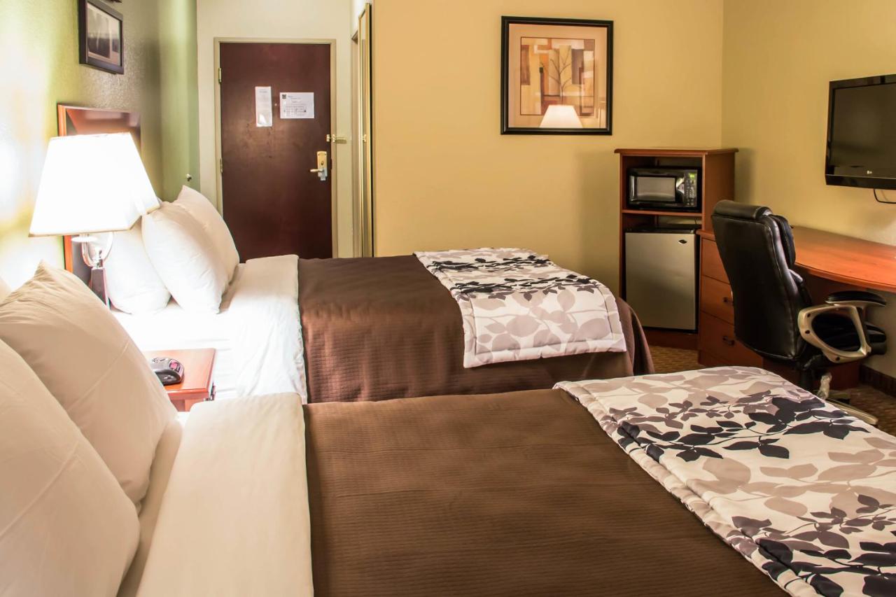 Queen Room with Three Queen Beds at Sleep Inn & Suites at Six Flags