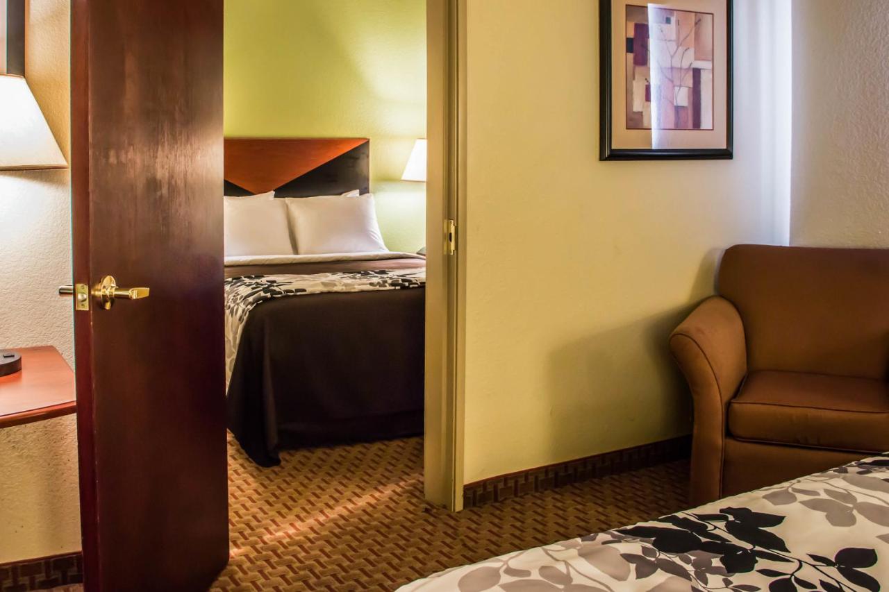 Queen Room with Three Queen Beds at Sleep Inn & Suites at Six Flags
